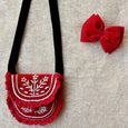 Embroidered bag and red velvet hair bow