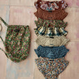 Seven embroidered panties in a pouch bag